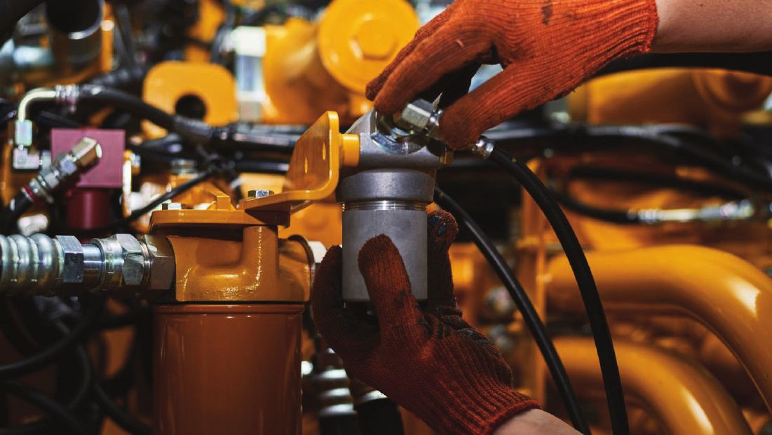 Technician servicing heavy machinery